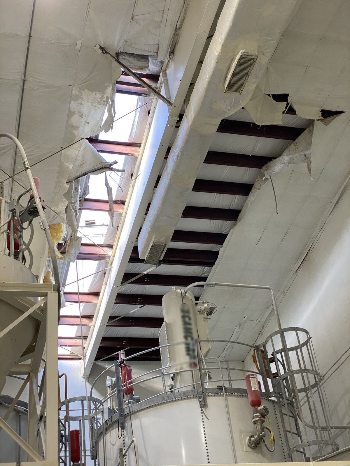 Damaged metal building insulation before replacement